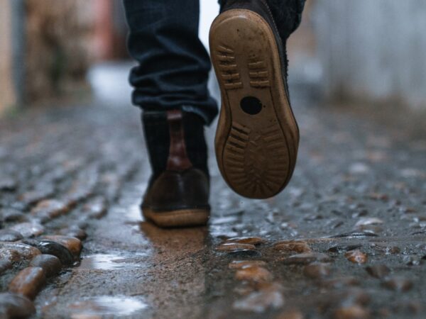 close-up photography of person walking on pavement